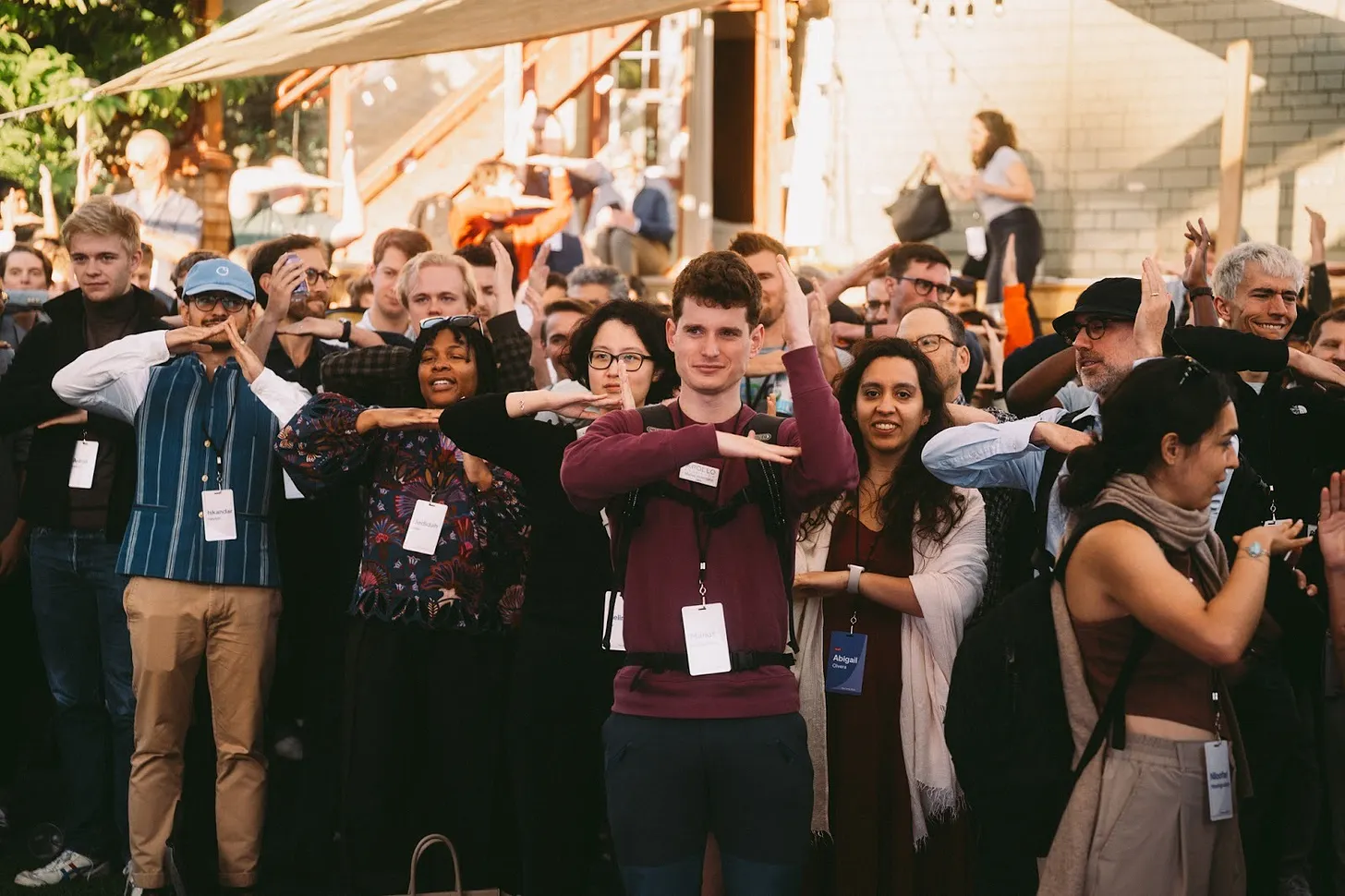 The Curve attendees making the curve gesture together